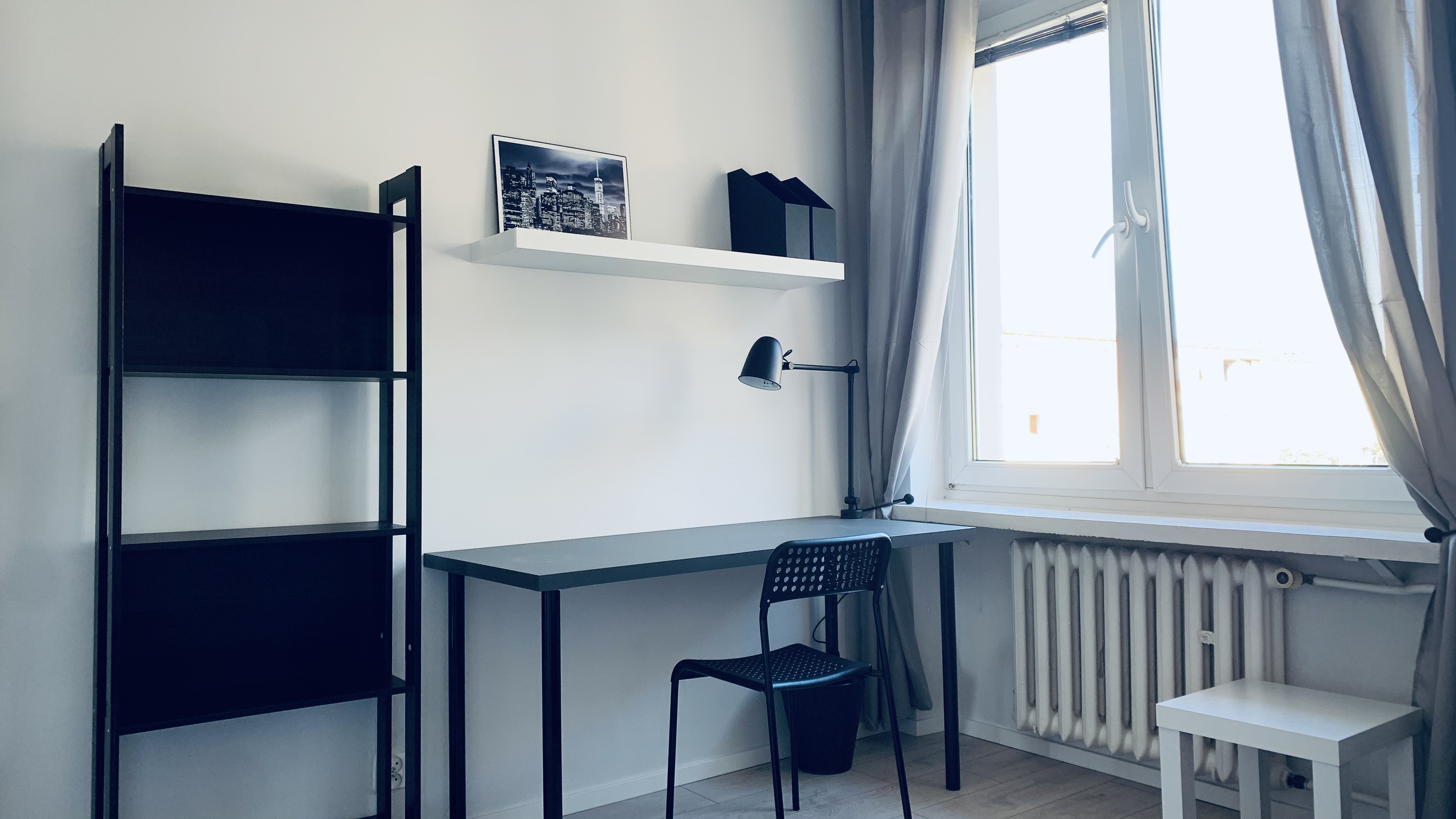 Desk and shelving beside the window in room #3