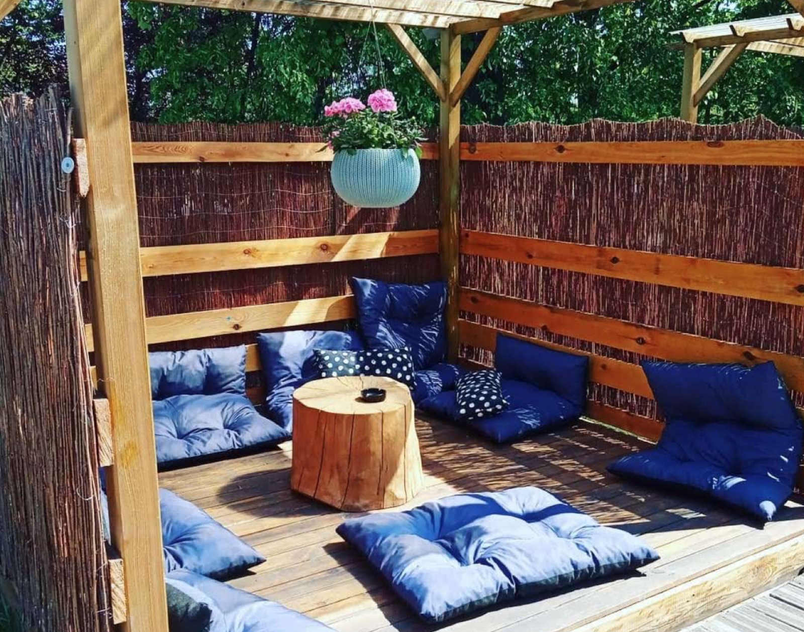 Wooden garden seating surrounded by greenery