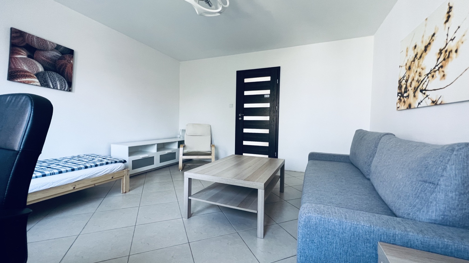 Private room with a sofa and a door