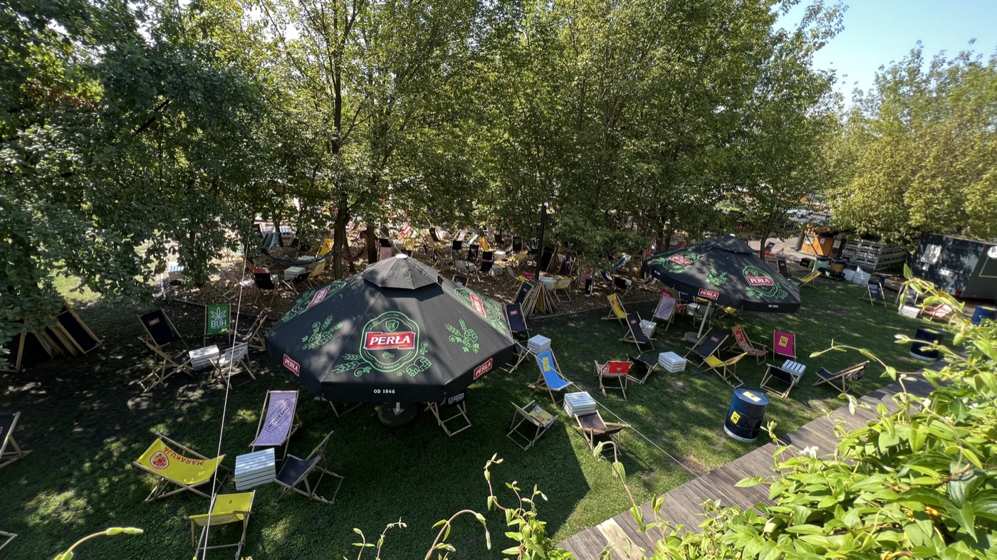 A seasonal riverside beach bar beneath the trees