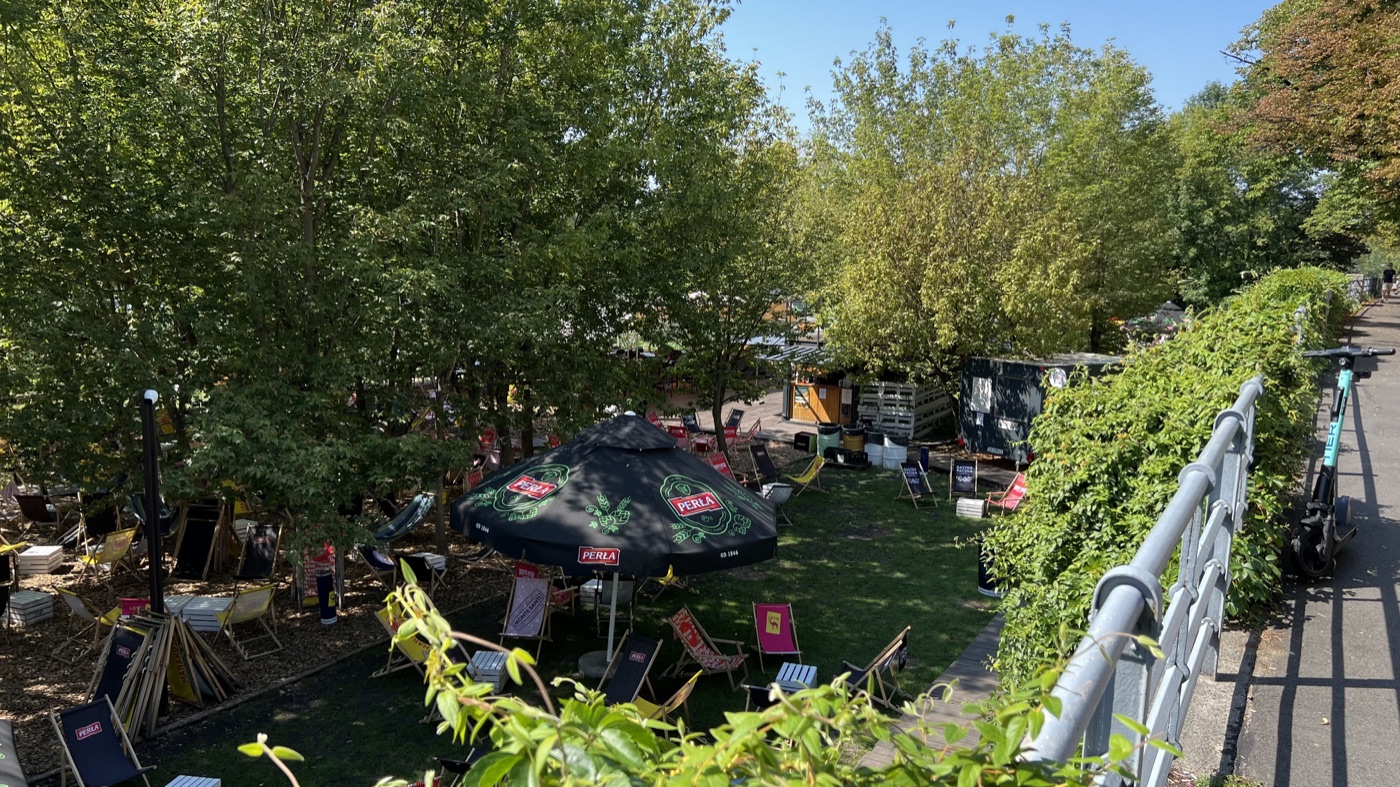 A riverside café garden among the trees